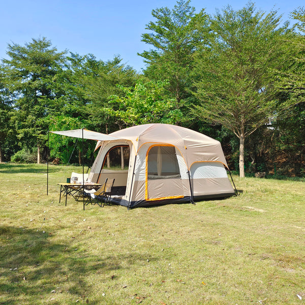 Une tente beige est installée dans un espace vert. Elle a un auvent et peut accueillir 4 personnes. 